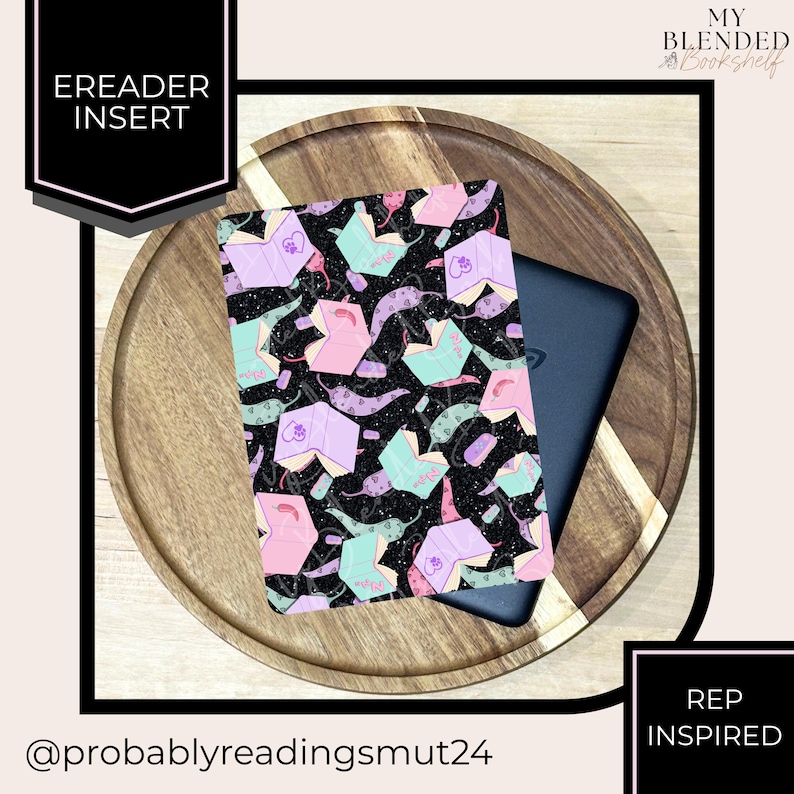 May include: An eReader insert with a black background and a pattern of open books in pastel colors. The insert is on a wooden tray with a black eReader. Text on the insert reads "EREADER INSERT". The text "REP INSPIRED" is also visible.