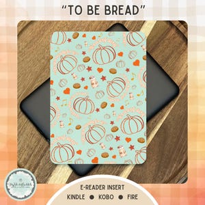 May include: An e-reader insert with a teal background featuring a pattern of pumpkins, stars, musical notes, and small animal illustrations. The text "TO BE BREAD" is at the top. The insert is designed for Kindle, Kobo, and Fire e-readers.