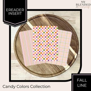 May include: Three rectangular ereader inserts featuring colorful patterns. One has vertical stripes in pink, orange, and purple. The center insert displays a multi-colored checkerboard pattern. The third insert features a grid of thin lines.
