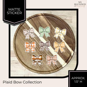 May include: A collection of matte stickers featuring plaid bow designs in various colors, including brown, green, yellow, orange, and tan. Each bow is approximately 1.5 inches in height. The text "Plaid Bow Collection" is visible.