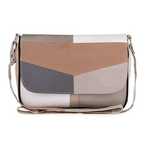 May include: A rectangular crossbody bag with a flap closure. The bag features a patchwork design in shades of gray, white, beige, and tan. It has a long, adjustable strap and silver-toned hardware. The bag is made of leather.