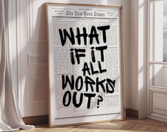May include: Framed print featuring a newspaper-style background with the headline "The New York Times." Bold, black text reads "WHAT IF IT ALL WORKS OUT?" The print is in a gold frame, leaning against a white wall.