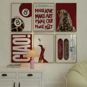 May include: A collection of framed art prints with gold frames. The prints feature various designs, including a leopard print eight ball, text that reads "Make Love, Make Art, Make Out, Make Money", a leopard, and skateboards.