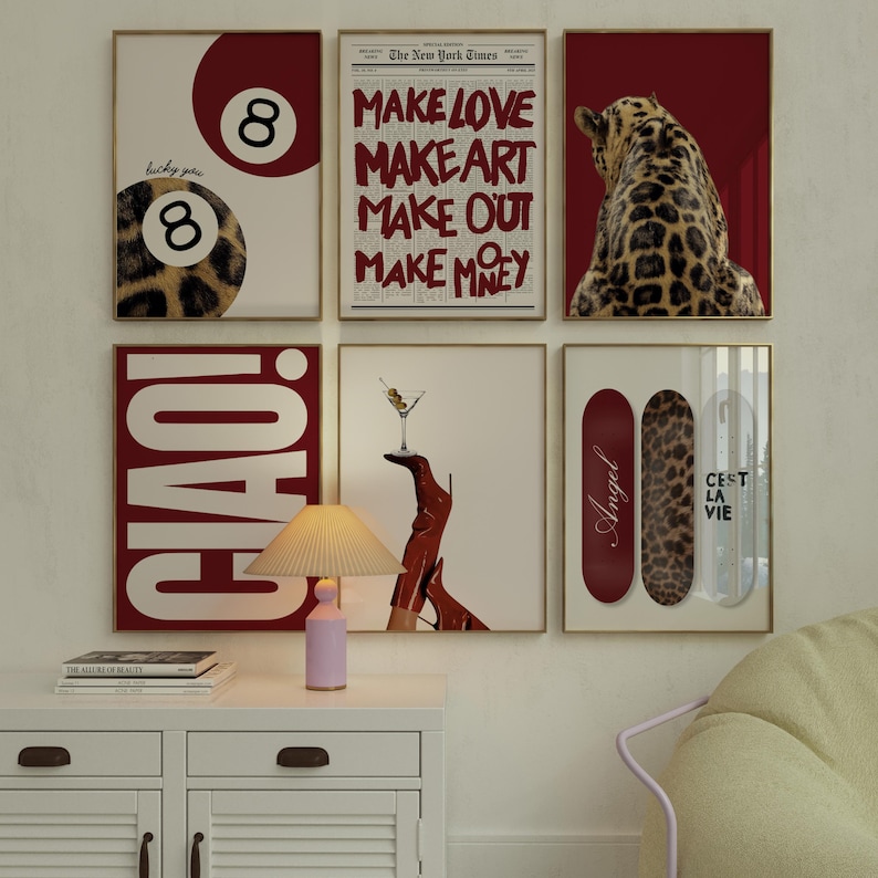 May include: A collection of framed art prints with gold frames. The prints feature various designs, including a leopard print eight ball, text that reads "Make Love, Make Art, Make Out, Make Money", a leopard, and skateboards.