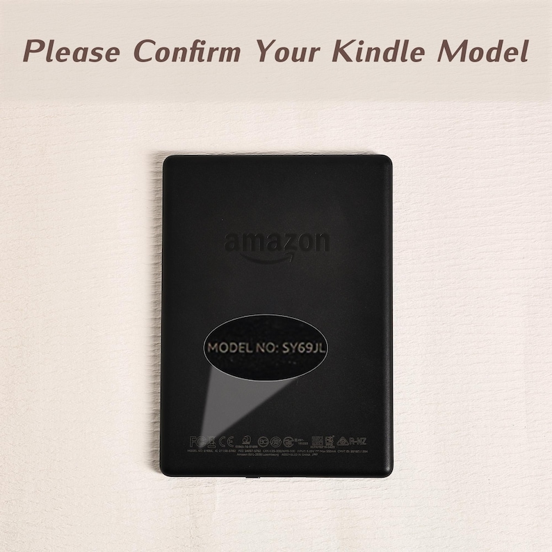 May include: A black Kindle e-reader back panel featuring the Amazon logo and a highlighted oval area displaying the text MODEL NO: SY69JL. The top of the image includes the text Please Confirm Your Kindle Model in a dark brown font color.