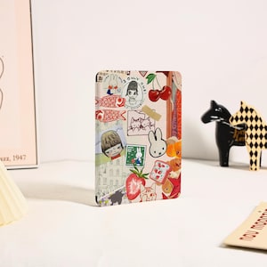 May include: A rectangular card featuring a collage of various illustrations including a white rabbit, red cherries, strawberries, a slice of toast, and a person with short hair. The design incorporates stamps and text reading ONLY ONE SHIGARAKI.