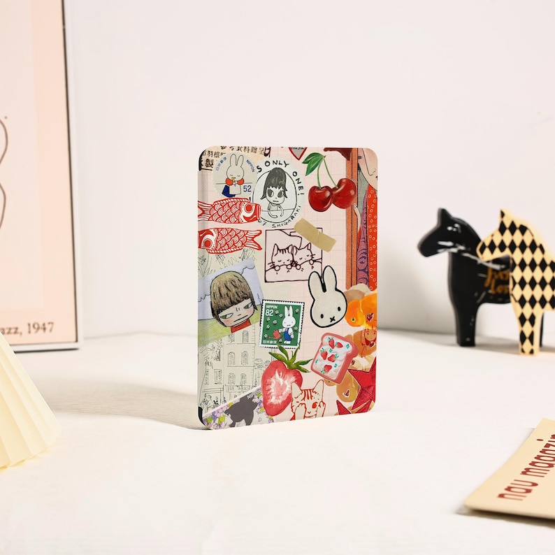 May include: A rectangular card featuring a collage of various illustrations including a white rabbit, red cherries, strawberries, a slice of toast, and a person with short hair. The design incorporates stamps and text reading ONLY ONE SHIGARAKI.