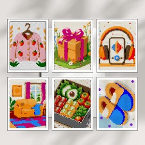 May include: A collection of six framed art prints. The prints depict various colorful illustrations, including a pink sweater with strawberry designs, a gift box with a pink bow, headphones with a music player, a living room scene, a bento box, and blue and orange slippers.
