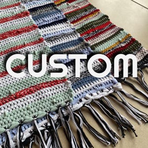 May include: Three woven rugs with fringe in various color combinations, including red, green, blue, and white. The rugs are labeled "CUSTOM".