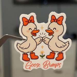 Goose Bumps Sticker – Cute Girl Geese Fist Bumping with Bows, Funny Pun Vinyl Decal, Waterproof Sticker for Laptops, Journals, Water Bottles