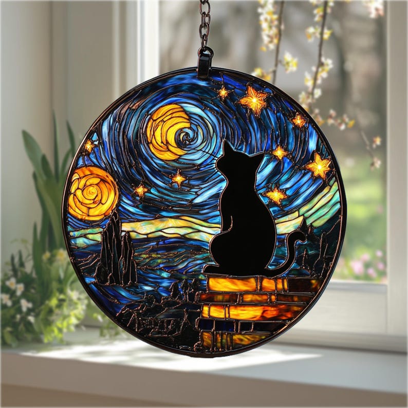 May include: Round stained glass window art featuring a black cat silhouette gazing at a starry night sky. The design includes swirling blues, yellows, and oranges, reminiscent of Van Gogh's style. The cat sits atop a brick wall.
