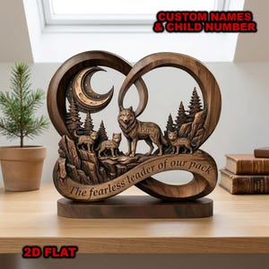 May include: A wooden heart-shaped sculpture featuring a wolf family scene. The sculpture includes a crescent moon, pine trees, and the words "Papa", "Luna", "Orion", and "Nova". The phrase "The fearless leader of our pack" is also present.