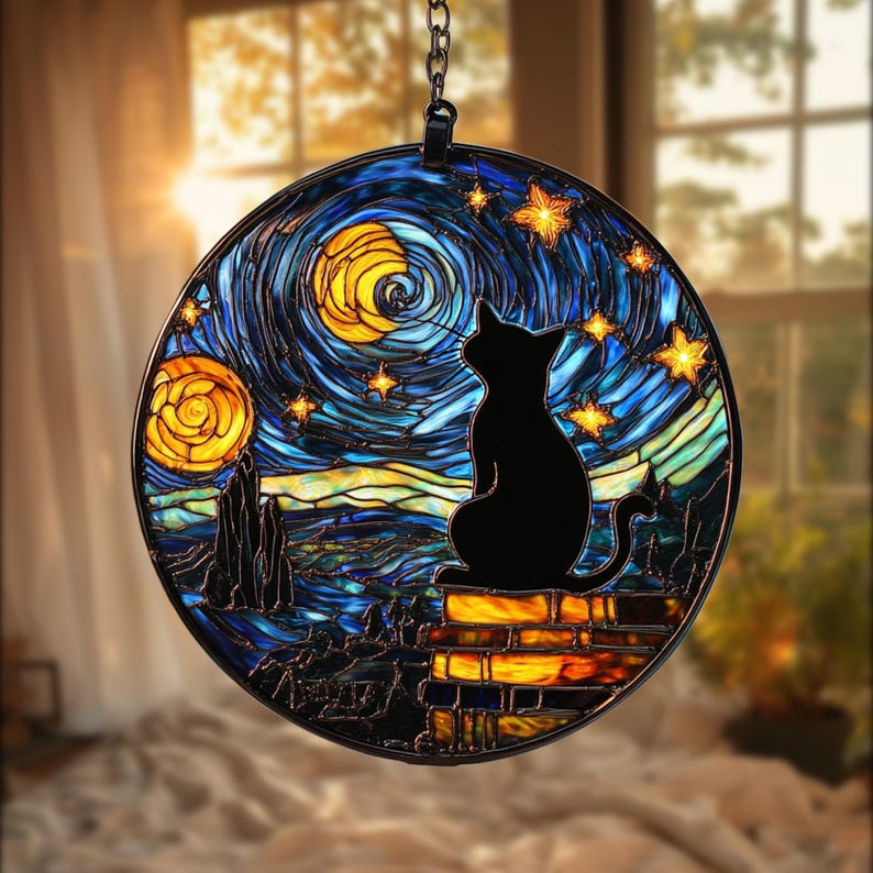 May include: Round stained glass window art featuring a black cat silhouette against a starry night sky. The design includes swirling blues, yellows, and oranges, with a brick wall base. The artwork is suspended by a chain.
