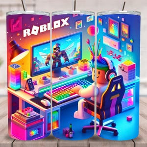 May include: A stainless steel tumbler featuring a vibrant design with the word "ROBLOX" and a gamer scene. The design includes a computer setup with a character, colorful lights, and a gaming chair. The tumbler has a silver straw.