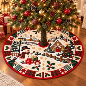 May include: A round quilted Christmas tree skirt featuring a winter village scene with a snowman, a gingerbread house, and wrapped gifts. The border is decorated with a red and green plaid pattern, holly leaves, and red berries.