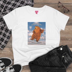 May include: White t-shirt with a graphic of a brown bear with the text "Please stop talking I'm overstimulated" printed on it.