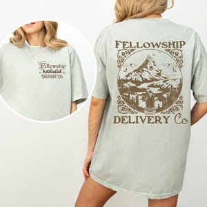 May include: A light green t-shirt with a brown graphic of a mountain range and the text "Fellowship Delivery Co."