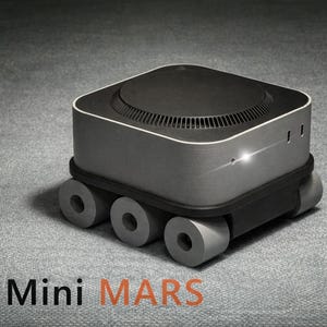 May include: A futuristic, gray and black device with a rounded top and cylindrical wheels. The device has the words "Mac Mini MARS" printed on the bottom.