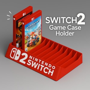 May include: A red Nintendo Switch game case holder with the text "SWITCH 2 Game Case Holder" in white. Two game cases are displayed. The holder has slots for multiple game cases and the Nintendo Switch logo.