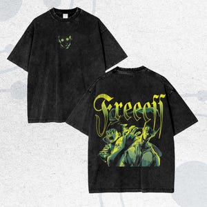 May include: Black t-shirt with a distressed look. The front features a small, neon green graphic. The back displays a larger graphic with the word "Freeeff" in yellow and green, along with an anime-style illustration.