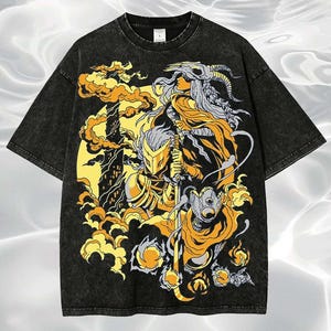 May include: Black graphic t-shirt featuring a detailed illustration of figures in gold, yellow, and gray tones. The design includes a warrior with a sword, a figure with a horned skull, and a futuristic character, set against a yellow background.