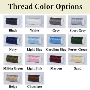 May include: Image displaying a variety of thread color options. The image shows spools of thread in colors such as black, white, grey, navy, light blue, forest green, pink, maroon, and beige. Text at the top reads "Thread Color Options."