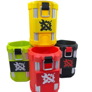 May include: A collection of four cylindrical containers in yellow, lime green, red, and black. Each container features vertical silver-toned accents, a top latch, and a rectangular patch on the front displaying a graphic of a wrench crossed with a gear.