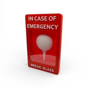 May include: A red box with the text "IN CASE OF EMERGENCY" and "BREAK GLASS" in white. Inside the box is a golf ball on a tee. The golf ball is white and has a dimpled surface.