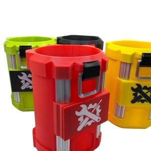 May include: Three cylindrical containers in red, yellow, and lime green, each featuring a black top handle, vertical silver-toned ribbed accents, and a rectangular patch on the front displaying a white graphic of a wrench crossed with a gear.