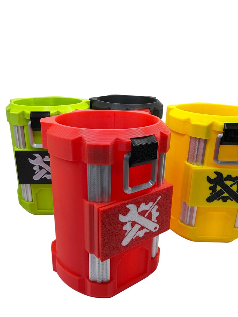 May include: Three cylindrical containers in red, yellow, and lime green, each featuring a black top handle, vertical silver-toned ribbed accents, and a rectangular patch on the front displaying a white graphic of a wrench crossed with a gear.