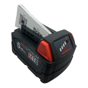 May include: A black and red power tool battery with a 5.0 Ah RedLithium M18 label. The battery has a fuel gauge with four bars and a small button on the side.