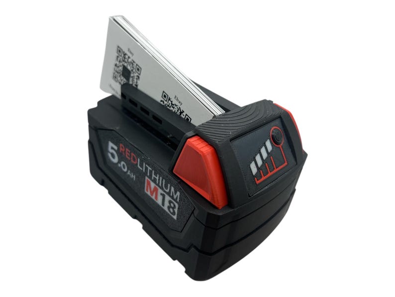 May include: A black and red power tool battery with a 5.0 Ah RedLithium M18 label. The battery has a fuel gauge with four bars and a small button on the side.