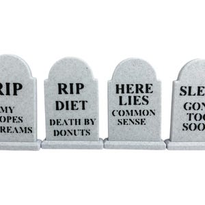 May include: Four gray tombstones with black text. The tombstones read: "RIP MY HOPES & DREAMS", "RIP DIET DEATH BY DONUTS", "HERE LIES COMMON SENSE", and "SLEEP GONE TOO SOON".