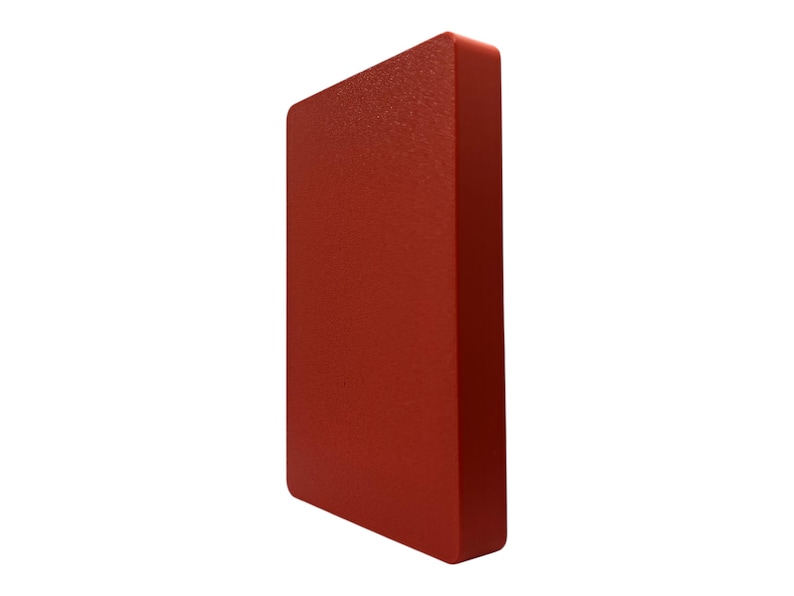 May include: A solid, rectangular object with a textured surface, presented in a vibrant shade of red. The object has rounded edges and a slightly angled perspective, showcasing its three-dimensional form against a white background.