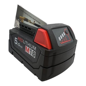 May include: A black and red Milwaukee REDLITHIUM M18 battery with a 5.0 Ah capacity. The battery has a fuel gauge with five bars and a red indicator light.