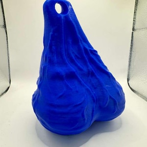May include: A bright blue, three-dimensional object with a textured, organic surface and a rounded, bulbous shape. The top section features a single, circular hole, while the lower portion consists of two distinct, rounded lobes.
