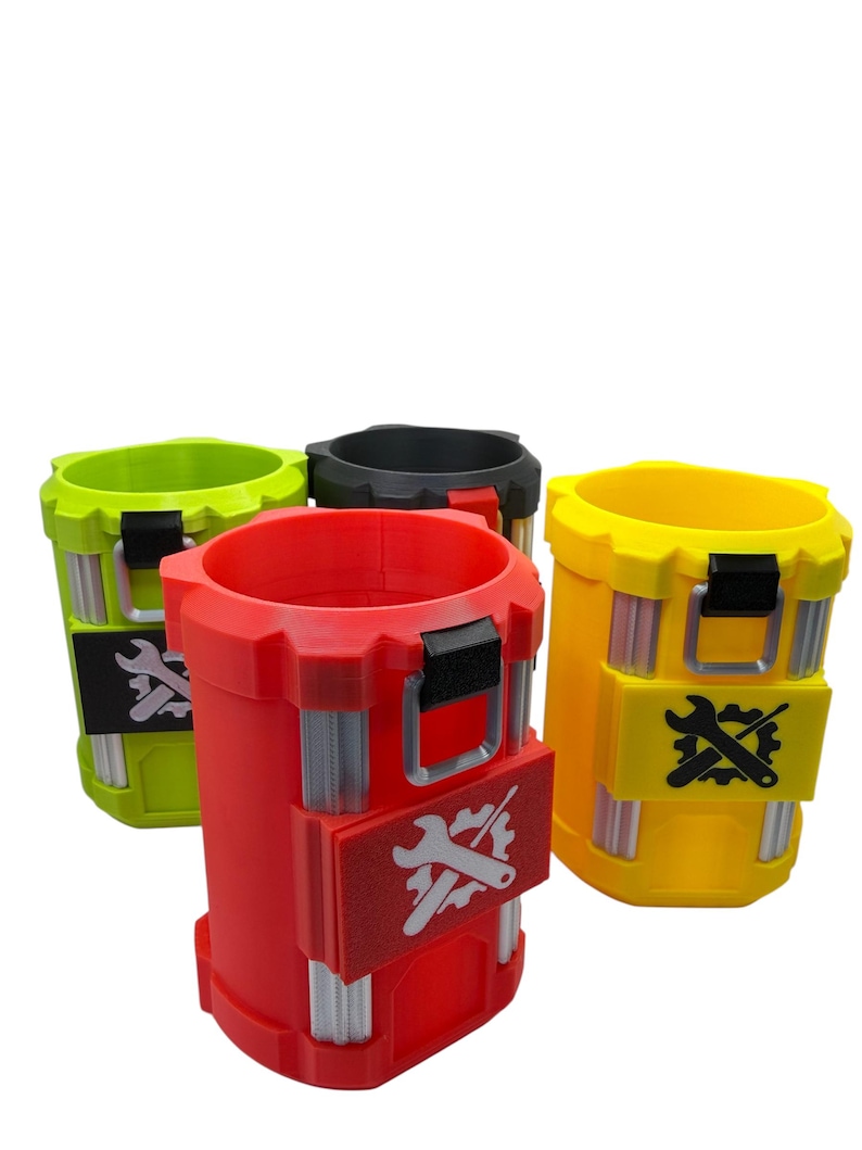 May include: A set of four cylindrical containers in lime green, black, red, and yellow. Each container features a vertical gear-like rim, silver-colored vertical accents, and a rectangular patch on the front displaying a white or black wrench and gear icon.