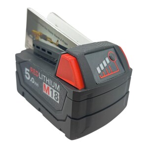 May include: A black and red power tool battery with the text "REDLITHIUM M18 5.0 Ah" on the side. The battery has a fuel gauge with five bars, four of which are lit up.