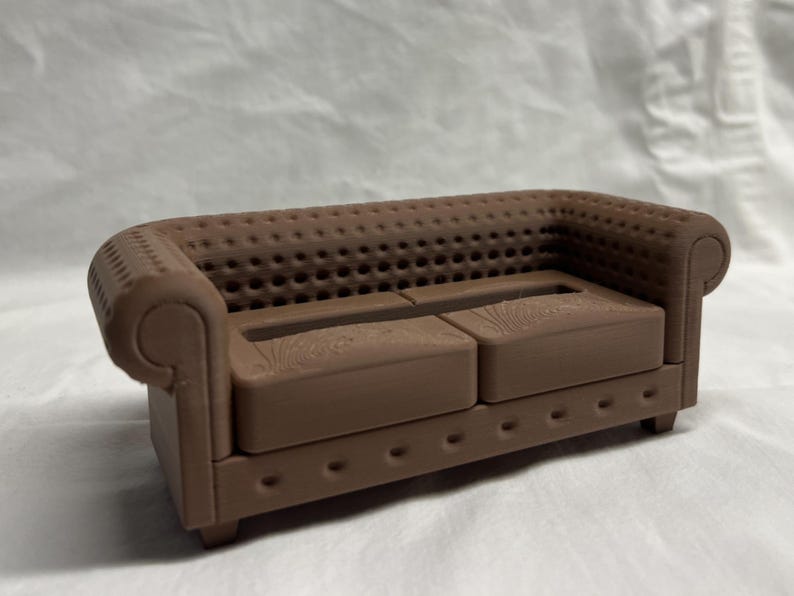 May include: A brown, tufted, two-seater sofa with a wood grain pattern on the cushions.