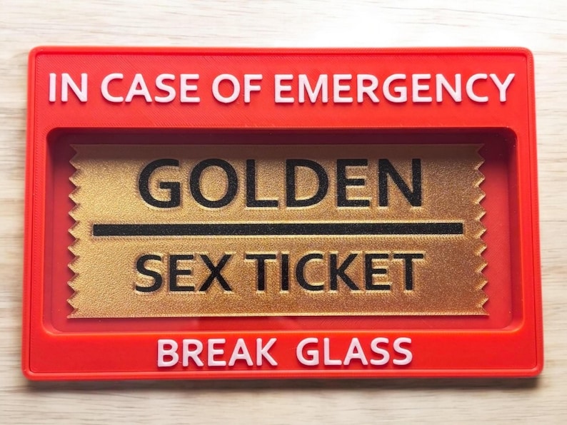 May include: Red break glass box with the text "IN CASE OF EMERGENCY" on the top and "BREAK GLASS" on the bottom. Inside the box is a gold ticket with the text "GOLDEN SEX TICKET" in black.