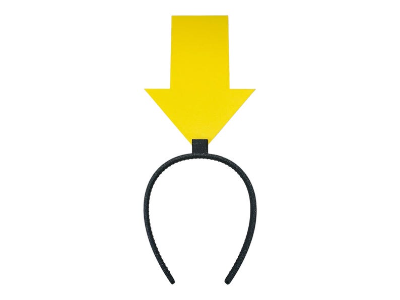 May include: A black headband with a bright yellow arrow pointing downwards. The arrow is rectangular with a pointed tip. The headband is a simple, curved design, and the arrow is attached to the top center.