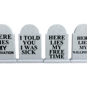 May include: Four gray tombstone decorations with black text. The tombstones read: "HERE LIES MY MOTIVATION", "I TOLD YOU I WAS SICK", "HERE LIES MY FREE TIME", and "HERE LIES MY WILLPOWER".