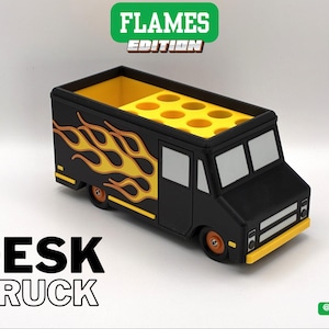 May include: Black desk truck with yellow and orange flame design on the side. The truck has a yellow interior with multiple circular compartments. The text "DESK TRUCK" is displayed on the front.