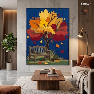 May include: A rectangular wall hanging quilt featuring a central tree with vibrant yellow, orange, and red autumn leaves. A wooden bench sits beneath the tree on a green patch, set against a deep blue background. The text ASNCraft is visible.