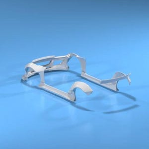 May include: White car frame components against a blue background. The image shows the front and side sections of a car frame, with curved and angular shapes. The parts are clean and appear to be new.
