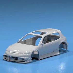 May include: A light gray model car with a hatchback design, featuring a sunroof and detailed body kit. The car is set against a solid blue background, showcasing its sleek lines and aerodynamic features.