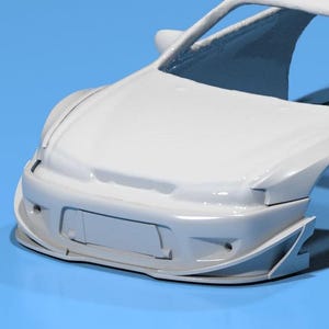 May include: A white car model, showcasing the front end with a detailed bumper, grille, and wheel arches. The model is set against a blue background, highlighting the car's design.