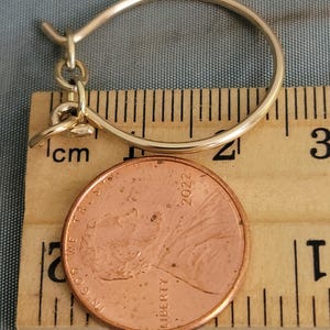 Medium charm holder with chain on ruler and penny to show size.  Gold filled.