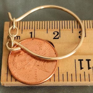 Large charm holder with chain on ruler and penny to show size.  Gold filled.