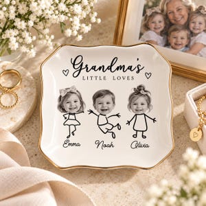 May include: A square white ceramic trinket dish with gold-toned edges. The center features the black text Grandma's LITTLE LOVES, two hearts, and three black and white child portraits with black ink stick-figure bodies labeled Emma, Noah, and Olivia.